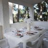 Tavolo da pranzo all'aperto con piatti e fiori.
