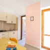Cucina con tavolo di legno e porta luminosa.