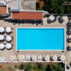 Vista aerea di piscina rettangolare e ombrelloni.